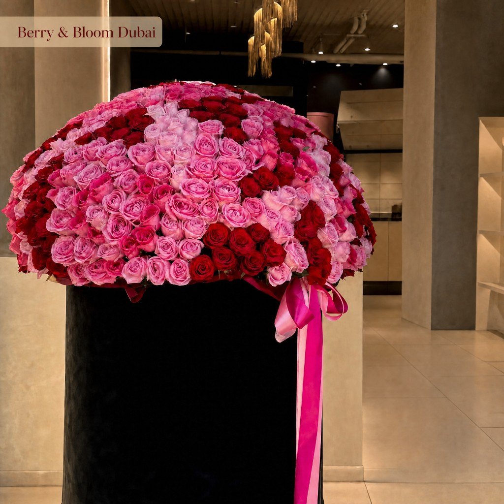 Red and pink roses as a heart in a black box